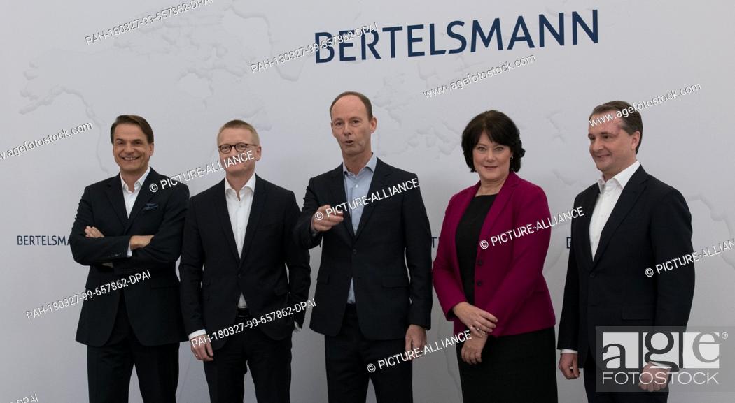 Stock Photo: 27 March 2018, Germany, Berlin: The Bertelsmann board poses for photographers prior to a press conference: Markus Dohle (l-r.
