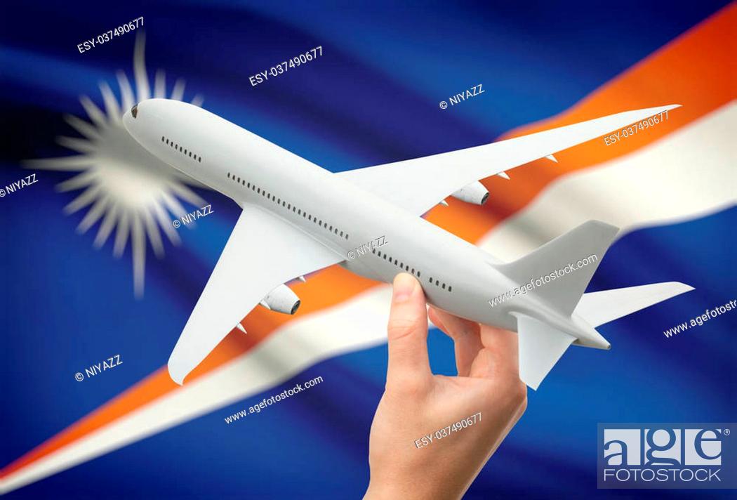 Stock Photo: Airplane in hand with national flag on background - Marshall Islands.