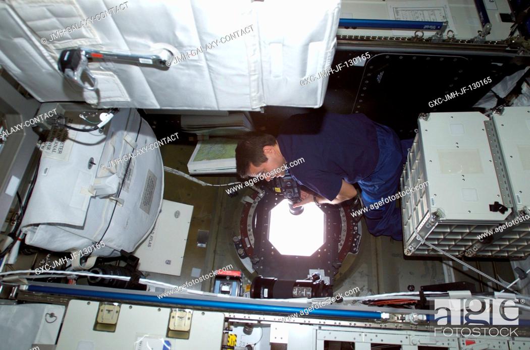 Stock Photo: Astronaut Daniel W. Bursch, Expedition Four flight engineer, takes Earth observation photos from the Destiny laboratory on the International Space Station (ISS).