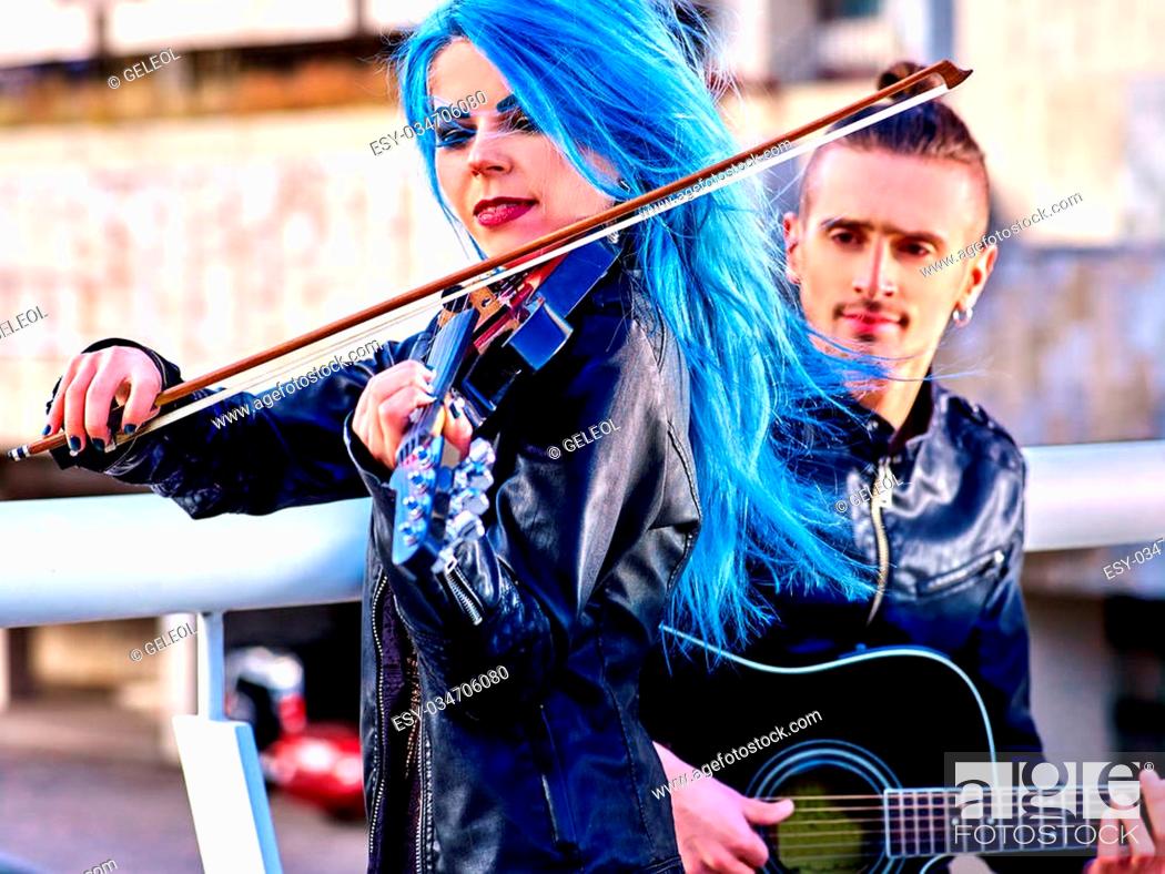 Music street performers with extravagant hairstyle girl violinist and man  guitarist on blue sky..., Stock Photo, Picture And Low Budget Royalty Free  Image. Pic. ESY-034706080 | agefotostock