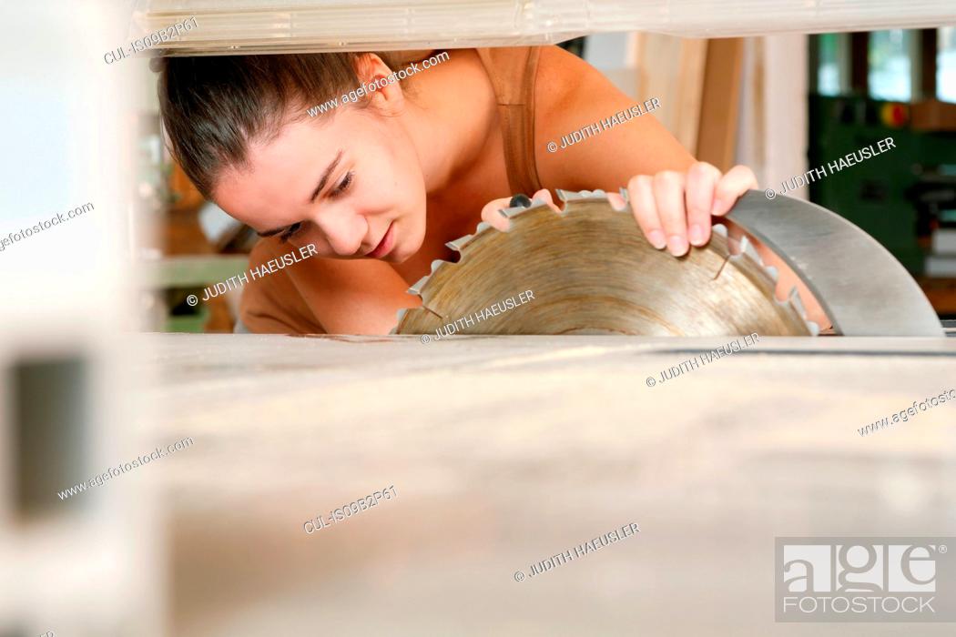 Stock Photo: Woman inspecting bench saw.