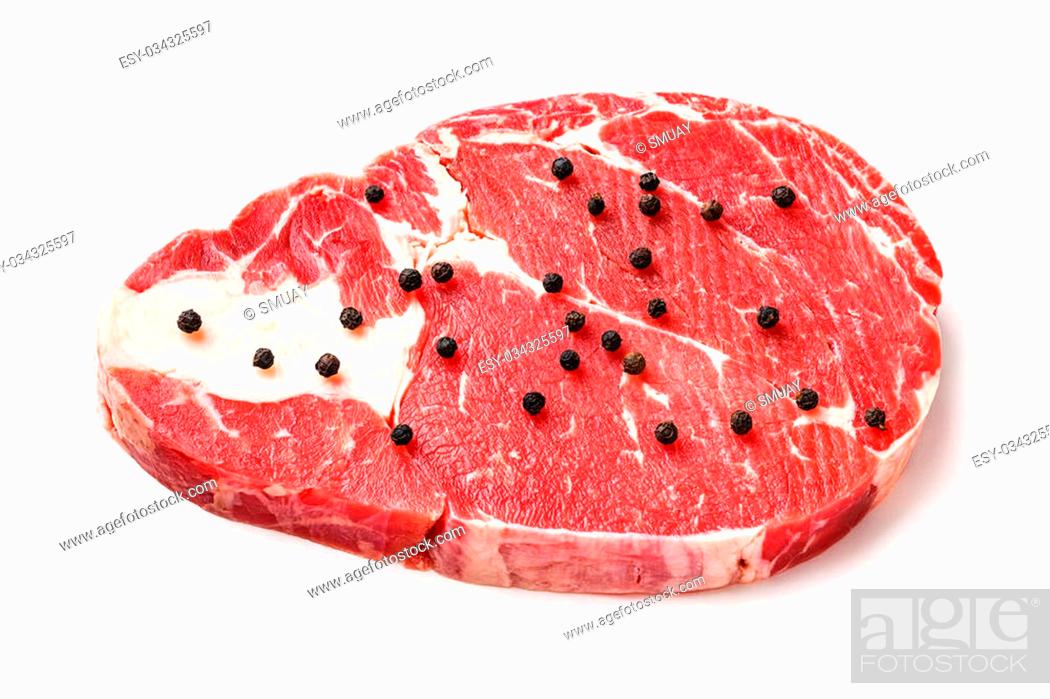 Stock Photo: Close up raw beef rib eye steak with black pepper isolated on white - deep focus image.