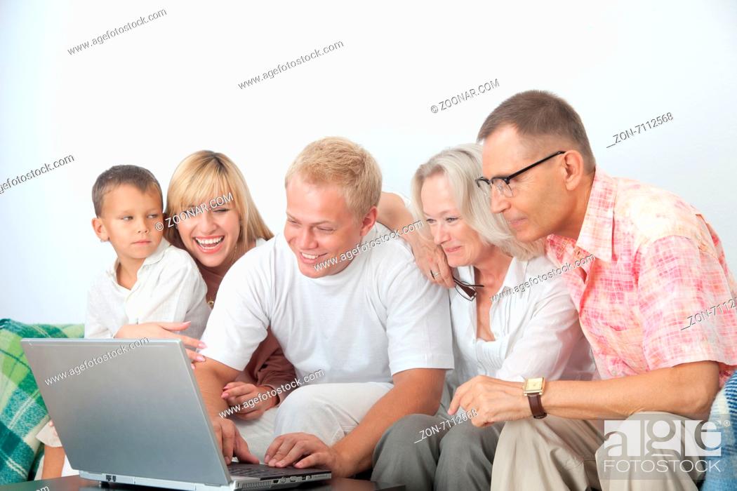 Imagen: Happy family work together at home on computer.