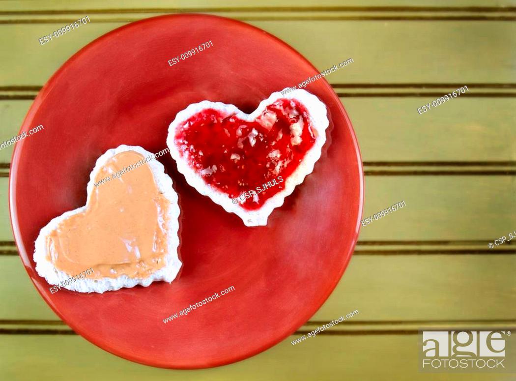 Stock Photo: Heart shape peanut butter and jelly sandwtich.