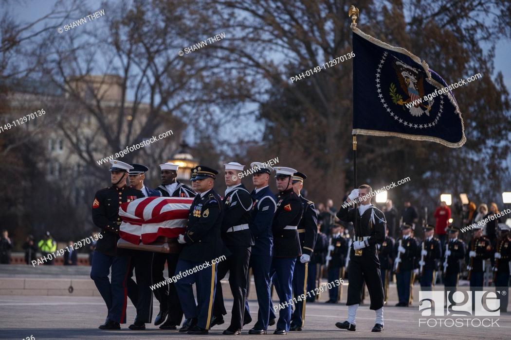 Stock Photo: Joint service members of a military casket team carry the casket of former President George H. W. Bush into the US Capitol.