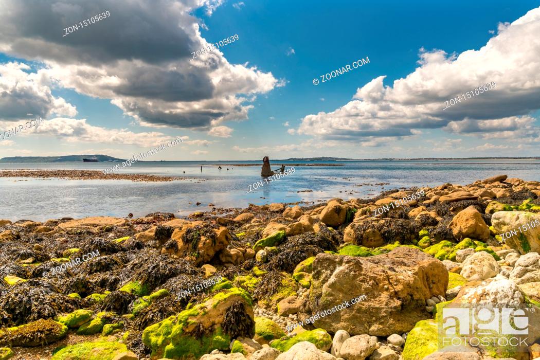 Stock Photo: Clouds over the Wreck of The Minx, Osmington Bay, with the Isle of Portland in the background, near Weymouth, Jurassic Coast, Dorset, UK.