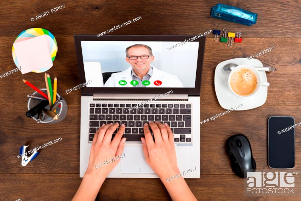 Stock Photo: Close-up Of Person Videochatting Online With Doctor On Laptop.