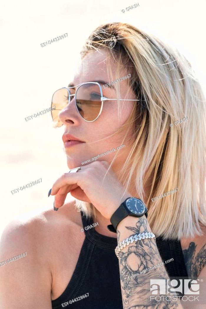 Portrait of a beautiful woman in sunglasses with a tattoo on her face,  close-up, Stock Photo, Picture And Low Budget Royalty Free Image. Pic.  ESY-044328667 | agefotostock