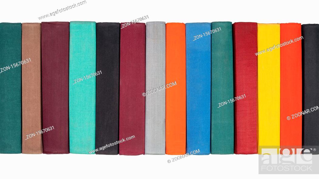 Stock Photo: Stack of old hardcover books on bookshelf. Close-up view of multicolored vintage hardback books: black, brown, purple, turquoise, gray, orange, blue, green, red.