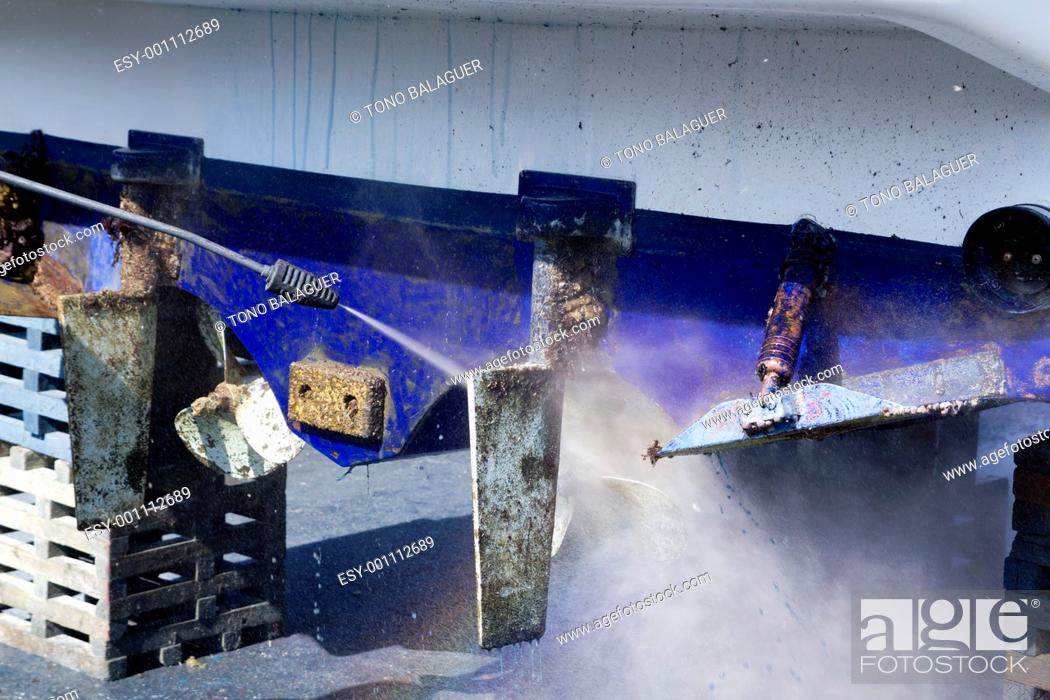Stock Photo: Boat hull cleaning water pressure washer barnacles antifouling and seaweed.