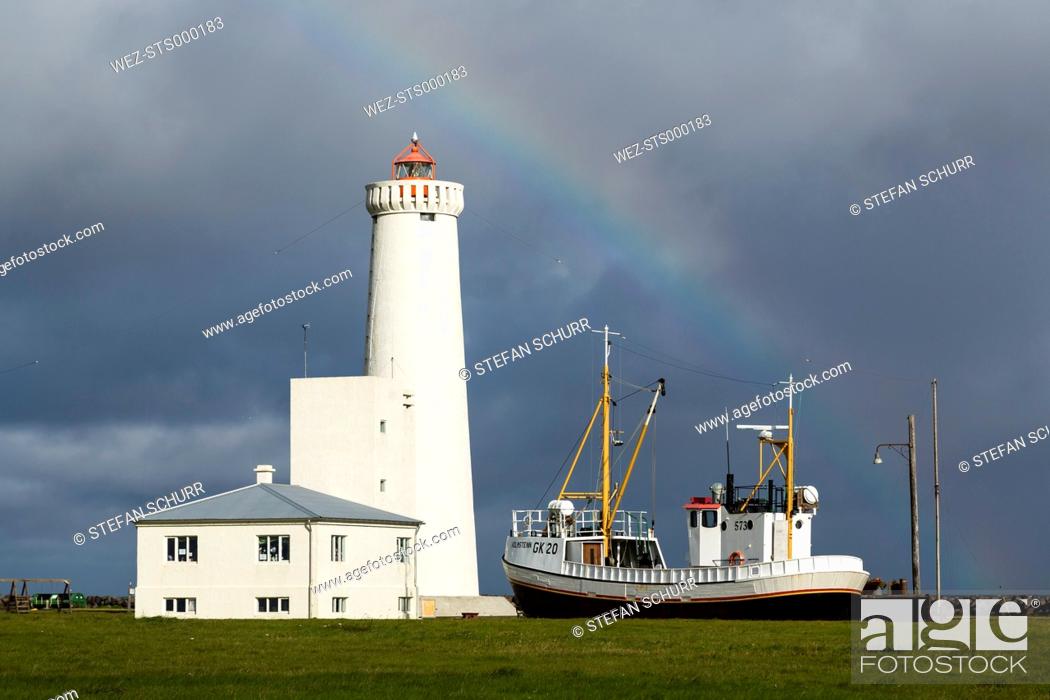 Stock Photo: Iceland, Gardur, Coastline with ship and lighthouse.