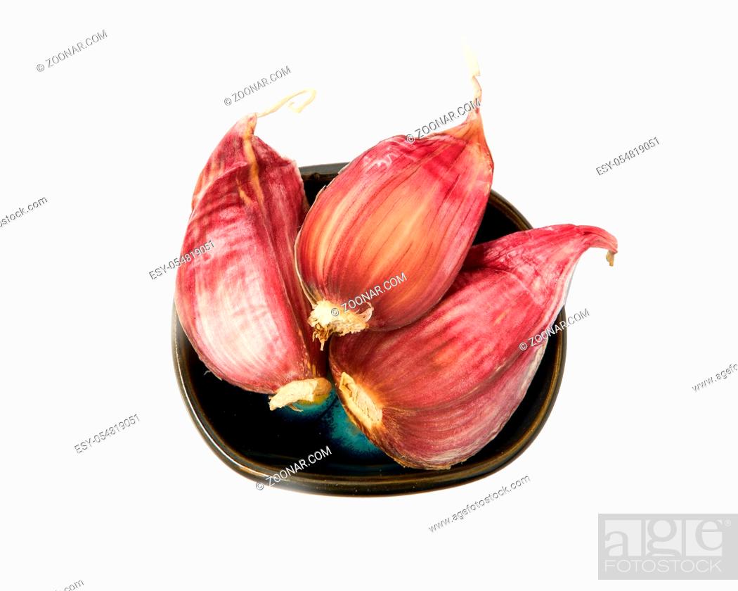 Stock Photo: Garlic in a bowl isolated on a white background. Spice on isolate. View from above.