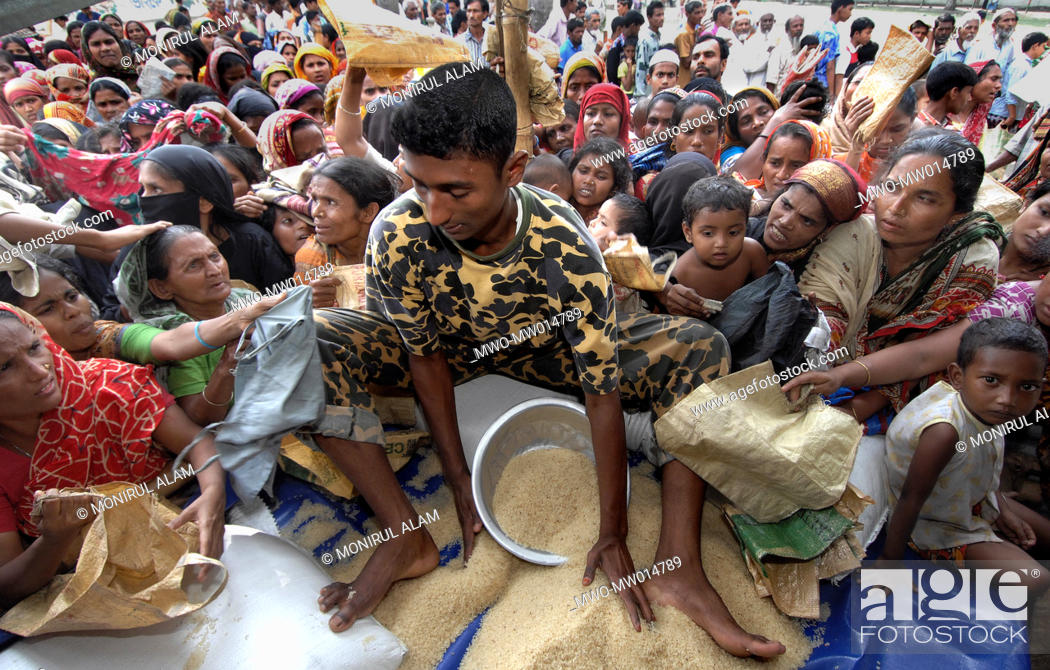 Stock Photo: People from low income group gather at a fair price rice shop, run by Bangladesh Rifles or BDR, in Dhaka, Bangladesh April 4, 2008.