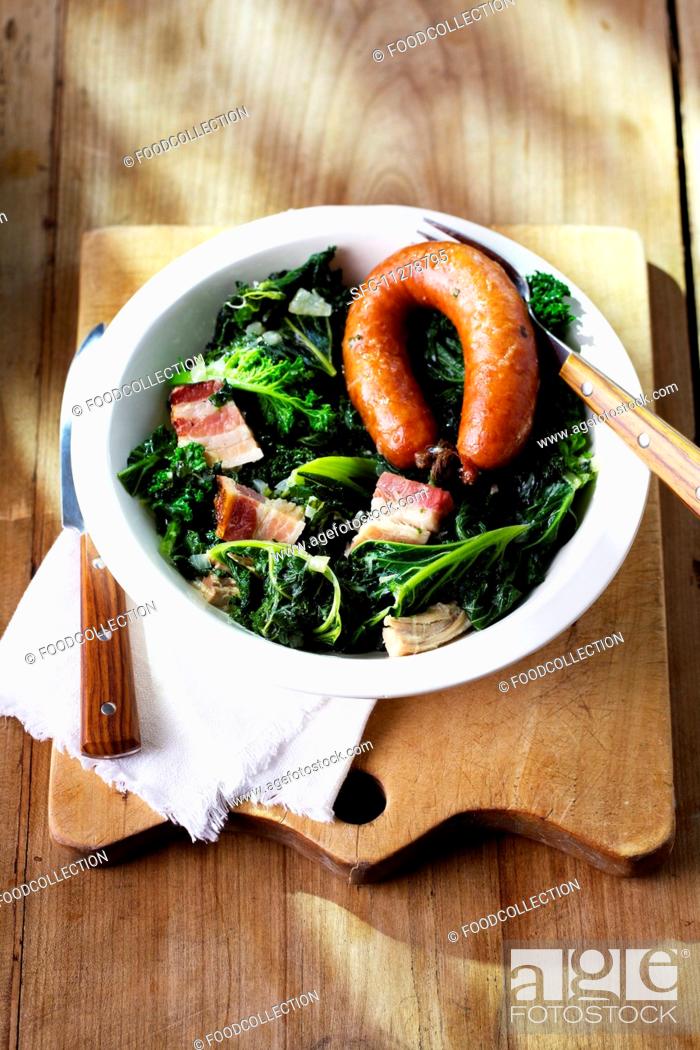 Stock Photo: Green kale with Pinkel (smoked sausage from bacon, groats and spices) on a plate.