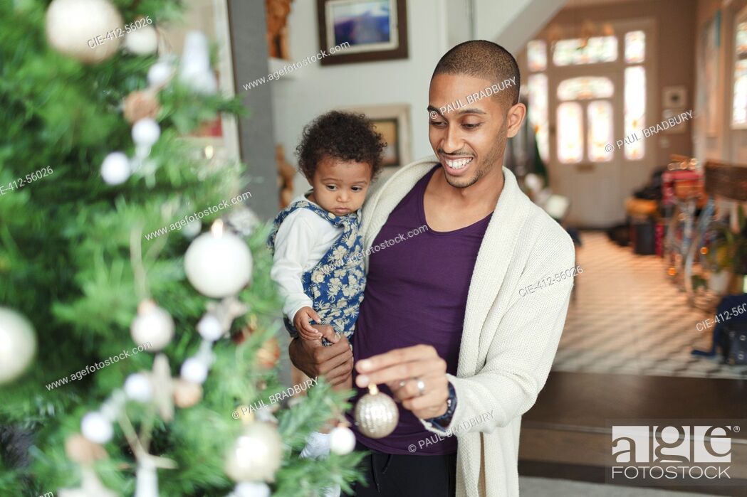 Stock Photo: Happy father and baby daughter decorating Christmas tree.