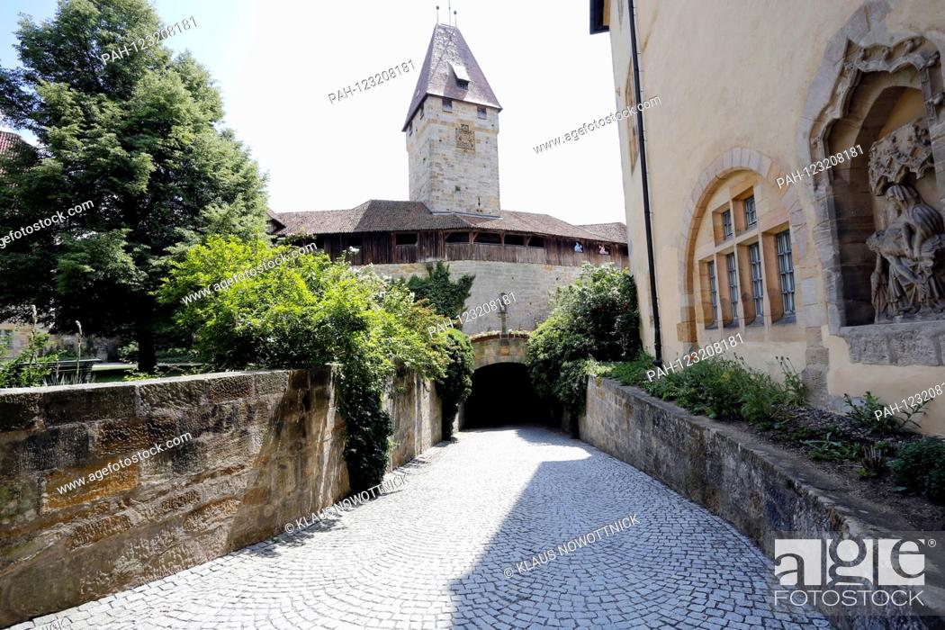 Stock Photo: Entrance to Coburg Fortress via the former drawbridge. The Veste Coburg, also known as the ""Frankish Crown"", rises high above the city with its huge walls and.