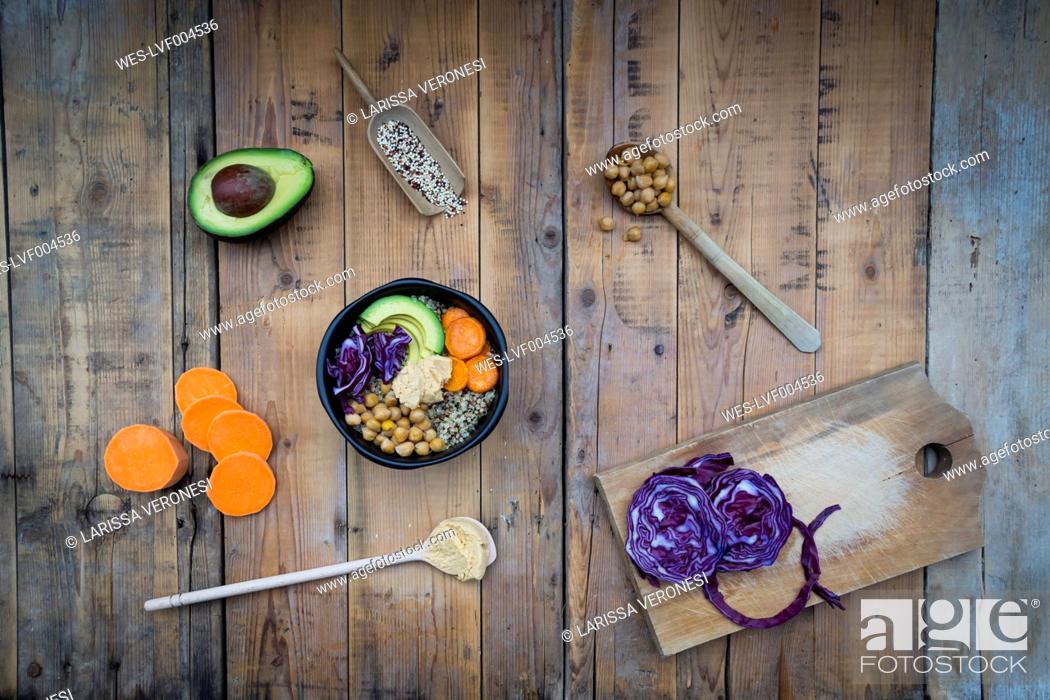 Stock Photo: Bowl of quinoa, avocado, roasted chick-peas, sweet potato, red cabbage and hummus.
