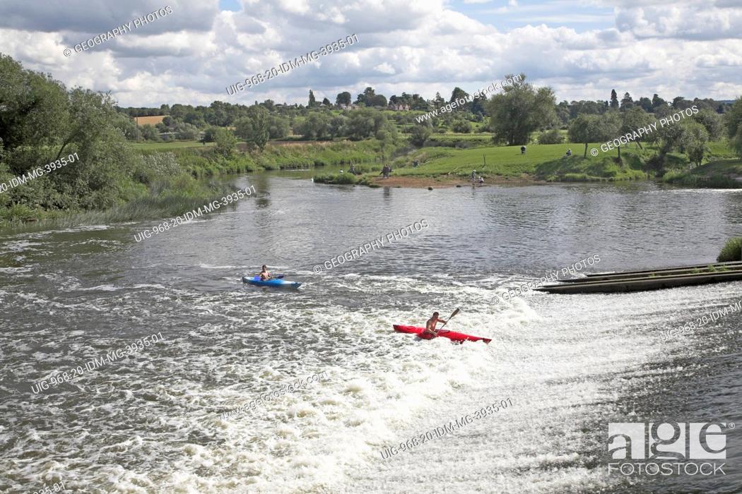 Stock Photo: Canoeing in white water from the weir on the River Avon in the Vale of Evesham, Fladbury, Worcestershire, England.