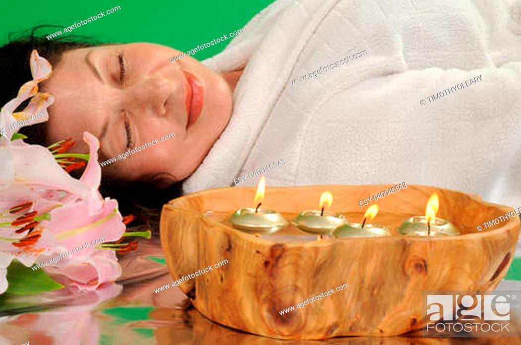 Stock Photo: Tranquil woman relaxing in a peaceful spa like setting.