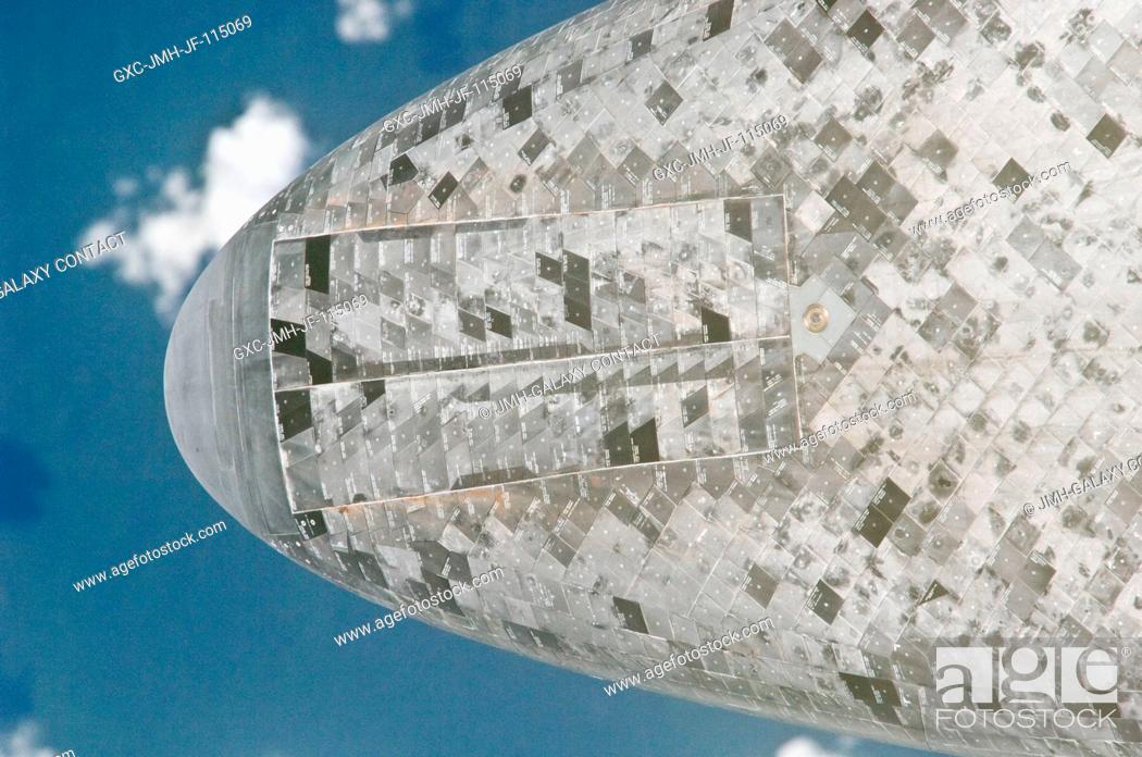 Stock Photo: This underside view of the nose of the space shuttle Discovery was provided by an Expedition 26 crew member during a survey of the approaching STS-133 vehicle.