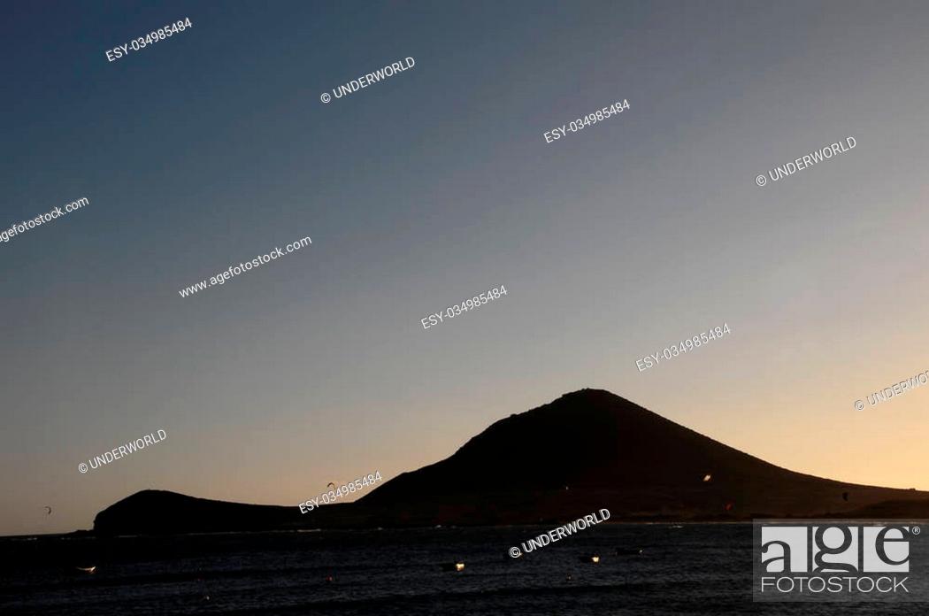 Stock Photo: Sunset on the Atlantic Ocean with a Mountain in Background El Medano Tenerife Canary Islands Spain.