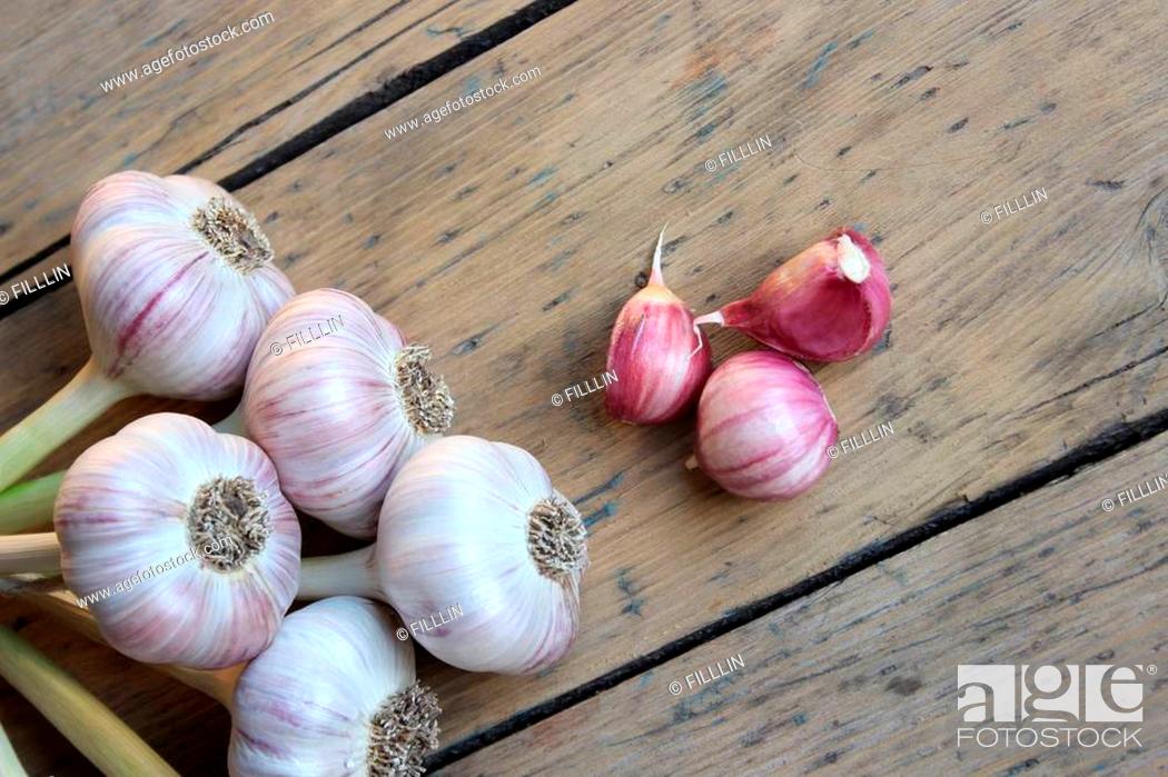 Stock Photo: Bunch of organic garlic on wooden boards.