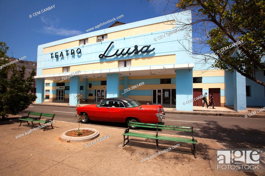 Stock Photo: Old American car in front of the Teatro Luisa at the Paseo del Prado or so called Boulevard in the city center, Cienfuegos, Cuba, Central America.