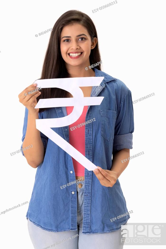 Stock Photo: A young woman holding Indian rupee symbol made of cardboard in hand.