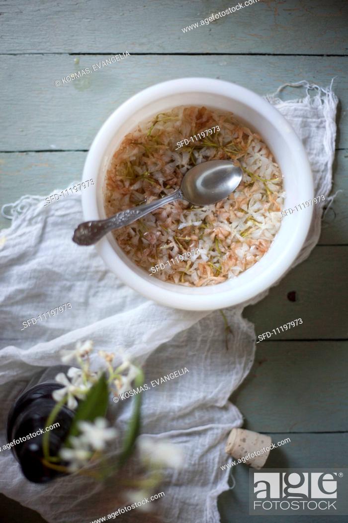 Stock Photo: Jasmine Flowers Soaking in a Bowl of Water.