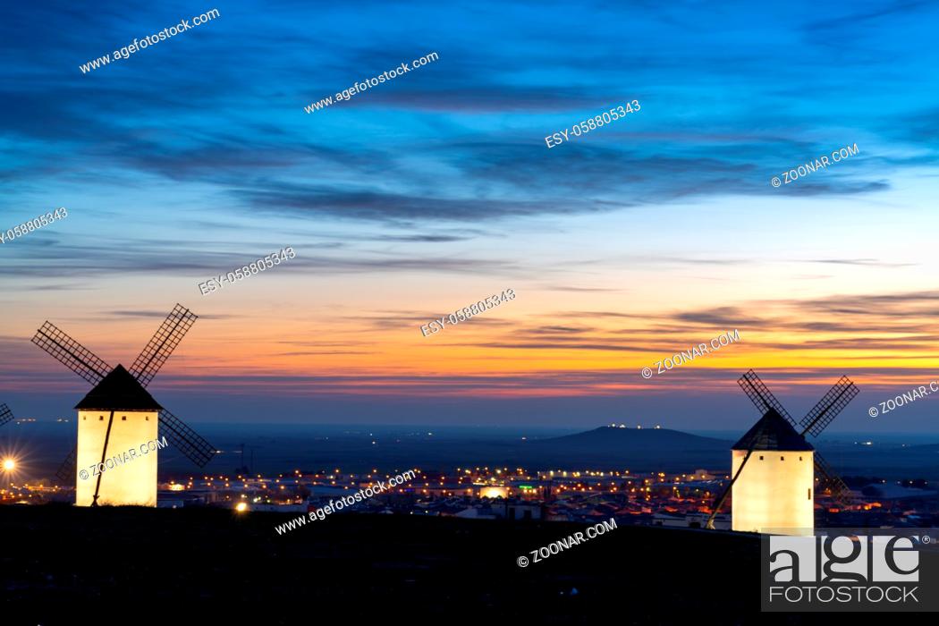 Stock Photo: A view of the historic white windmills of La Mancha above the town of Campo de Criptana at sunset.