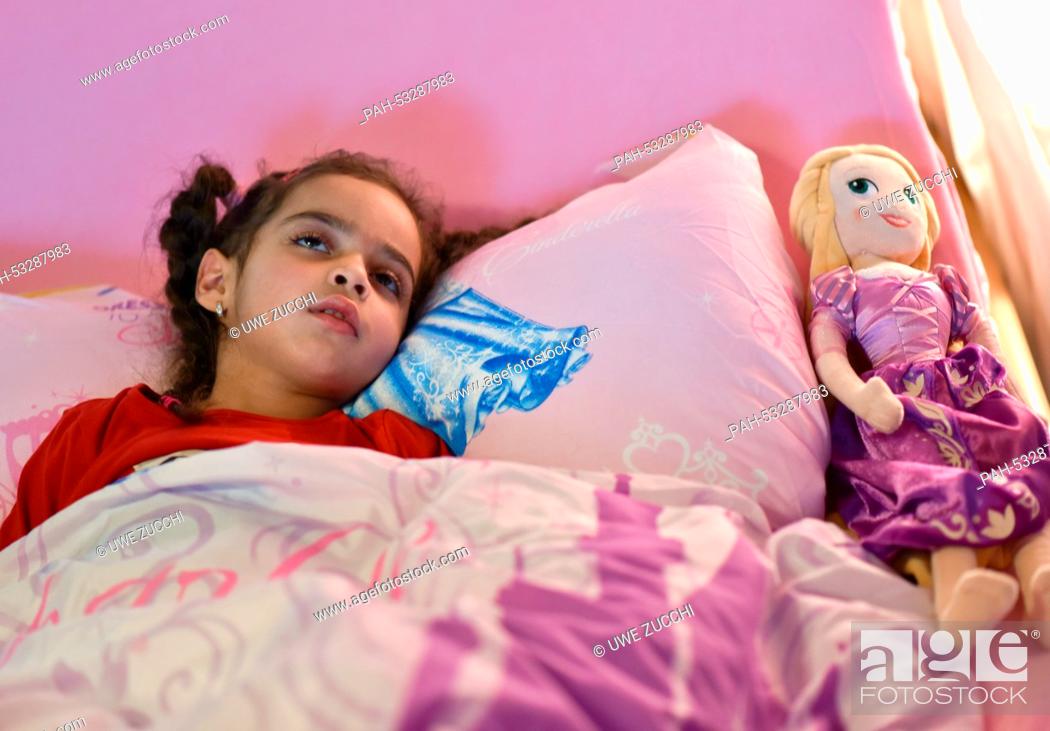 Stock Photo: Sick Aliana lies in her bed in Bad Hersefeld, Germany, 30 October 2014. Aliana suffers from chronic, progressive encephalitis (SSPE).