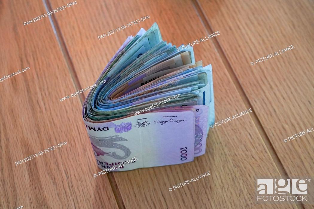 Stock Photo: 02 July 2020, Albania, Kruja: A bundle of Albanian lek banknotes from the Central Bank of Albania of Banka e Shqipërisë. Photo: Peter Endig/dpa-Zentralbild/ZB.