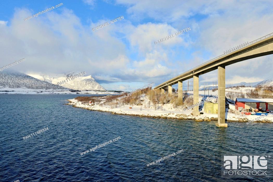 Stock Photo: Piers from the Andøy Bridge by the small village Risoyhamn in the winterly white landscape of Vesterålen, 10 March 2017 | usage worldwide.