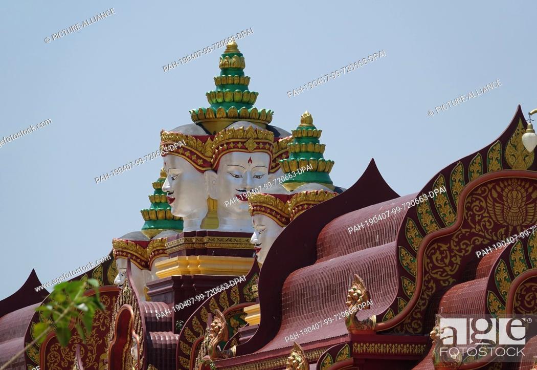 Stock Photo: 04 March 2019, Thailand, Ao Luek Distrikt: Pagoda roof and a statue with several faces on the property in Wat Maha That Wachira Mongkol or also Wat Bang Tong.
