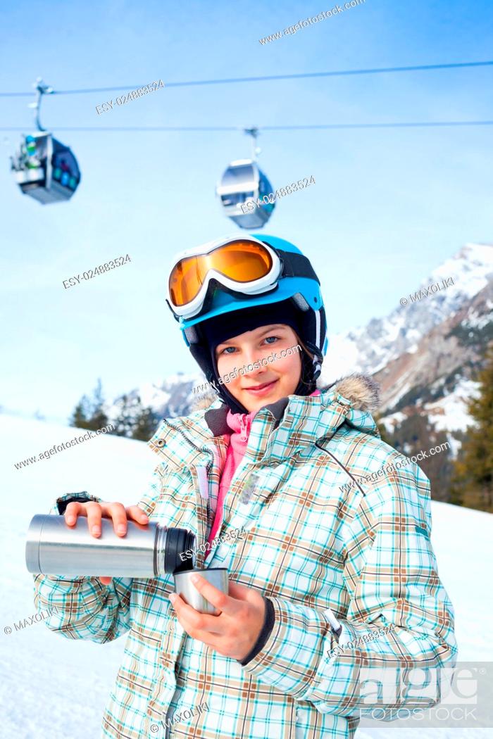 Stock Photo: Ski, skier, winter. Lovely girl has a fun on ski - resting and drinking tea.