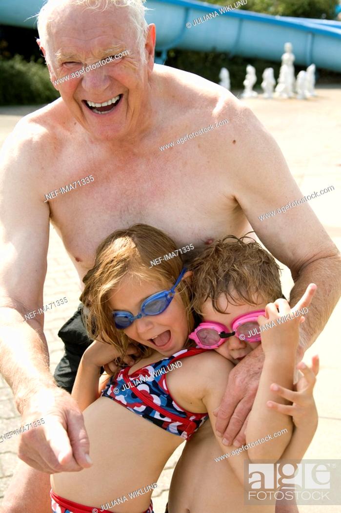 Stock Photo: Grandfather playing with his grandchildren on the beach, Denmark.