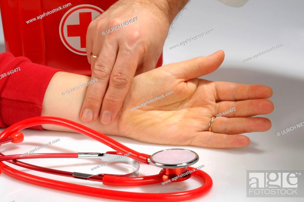 Stock Photo: Doctor checking a patient's pulse.
