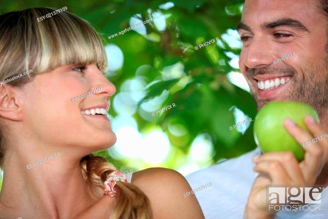 Stock Photo: Couple with apple in hand.