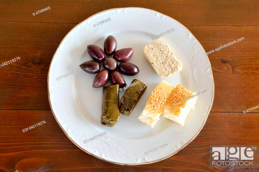 Stock Photo: Fasting food concept of plate with olives, dolma, halva and lagana.