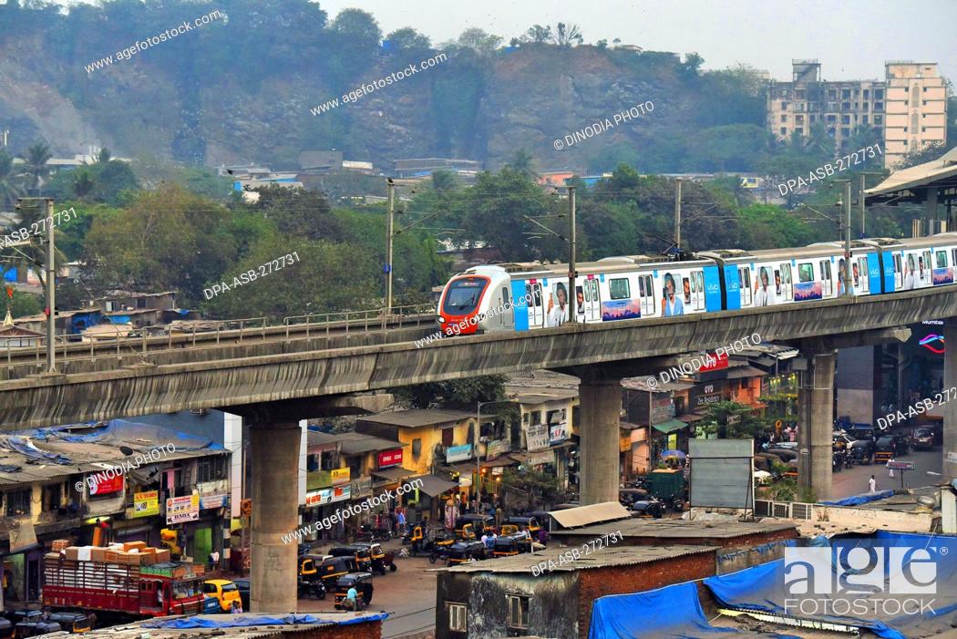 Photo de stock: Metro train near Asalpha railway station, Mumbai, Maharashtra, India, Asia.