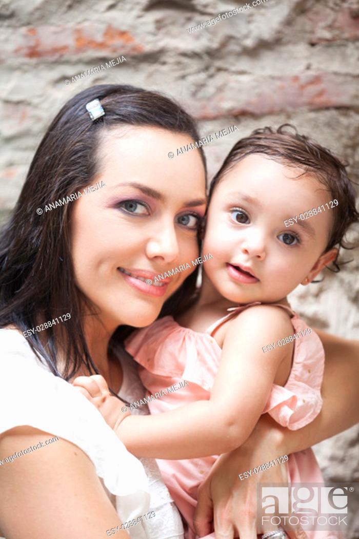 Stock Photo: Mother and her baby girl looking at the camera.
