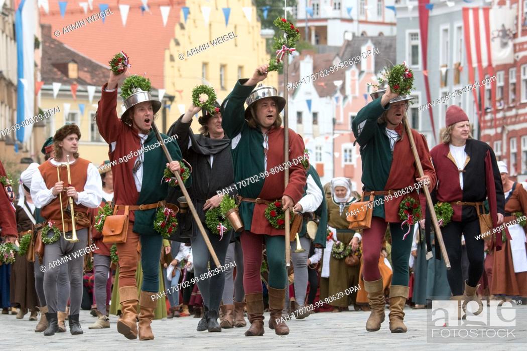 Stock Photo: People in historical costumes, photographed at the parade of the Landshut Wedding (German: 'Landshuter Hochzeit') in the old town of Landshut, Germany.