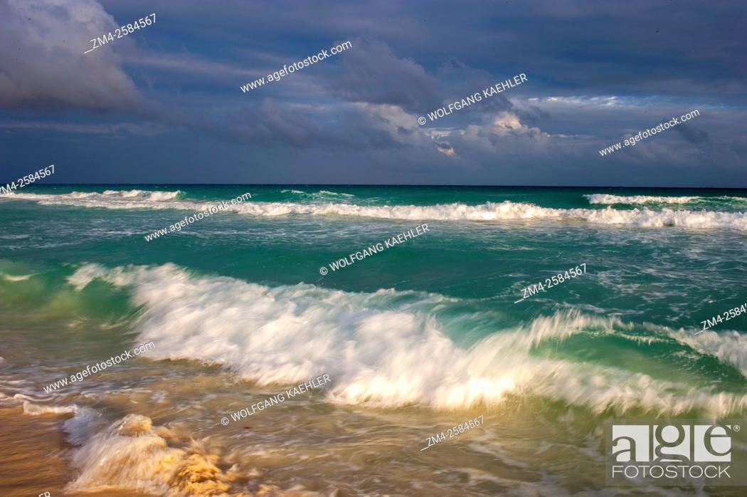 Stock Photo: Waves crashing on a white sand beach during a storm along the east coast of the Yucatán Peninsula on the Caribbean Sea at Playa del Carmen on the Riviera Maya.