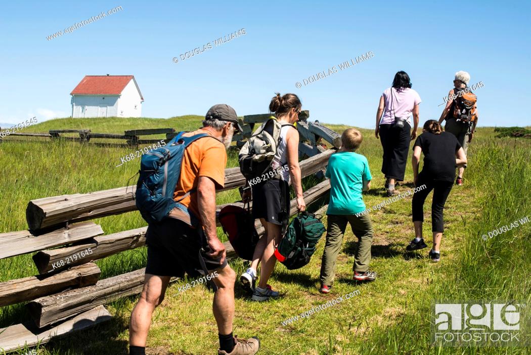 Stock Photo: A group of people walk by the split rail fence, East Point Park, National Park Reserve, Saturna Island, Gulf Islands, BC, Canada.