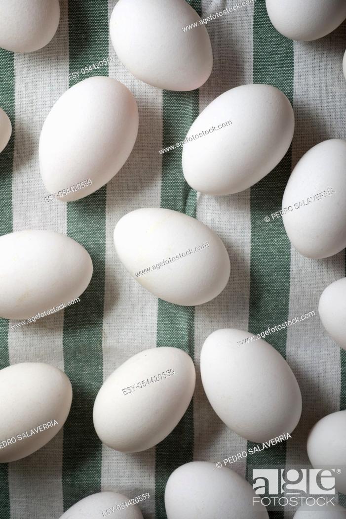 Stock Photo: Chicken eggs on a cloth tablecloth.