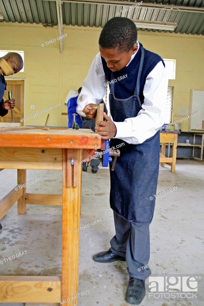 Stock Photo: School boy sanding wood in woodwork classroom, St Mark's School, Mbabane, Hhohho, Kingdom of Swaziland.