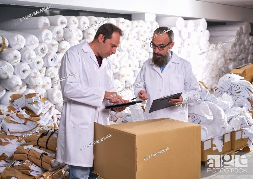 Stock Photo: warehouse supervisor and manager men in fashion textile factory.