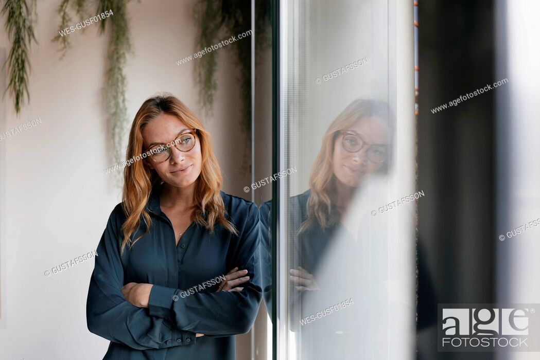 Stock Photo: Businesswoman looking out of window.