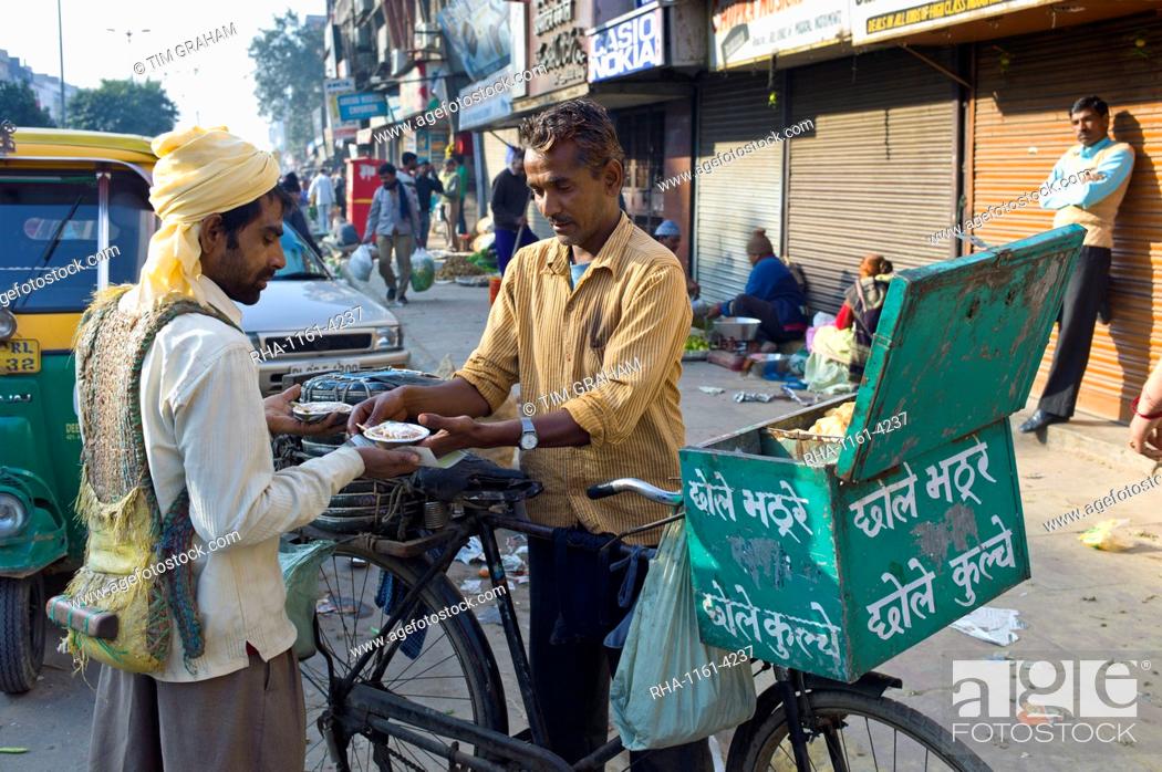 Stock Photo: Old Delhi, Daryagang fruit and vegetable market with curry sold from a bicycle stall, India.