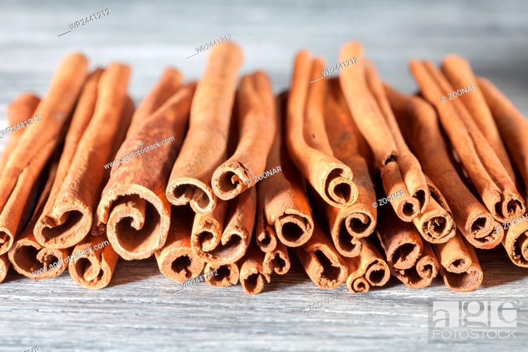 Stock Photo: Cinnamon sticks isolated on white wooden table.